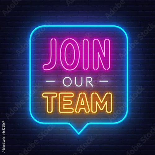 Join Our Team neon sign on a brick background.