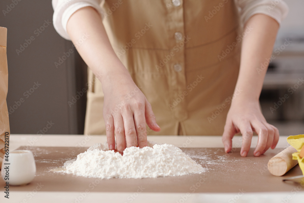 Close-up image of person mixing mooncake dough ingredients when cooking at home for mid autumn festival Close-up image of person mixing mooncake dough ingredients when cooking at home for mid autumn festival