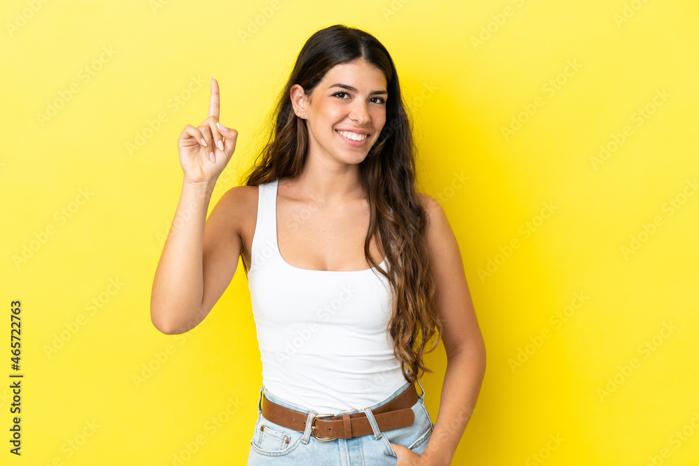 Young caucasian woman isolated on yellow background pointing up a great idea Young caucasian woman isolated on yellow background pointing up a great idea