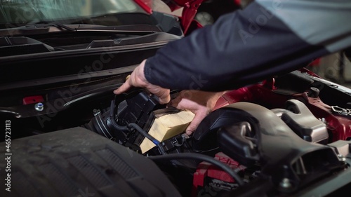 Replacing the car's air filter with a new one, maintenance, close-up