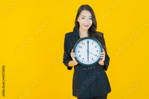 Portrait beautiful young asian woman show alarm or clock