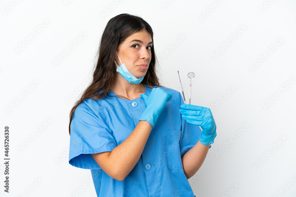 Dentist woman holding tools over isolated white background proud and self-satisfied Dentist woman holding tools over isolated white background proud and self-satisfied
