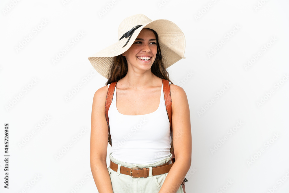 Young caucasian woman wearing a Pamela in summer holidays isolated on white background looking side Young caucasian woman wearing a Pamela in summer holidays isolated on white background looking side