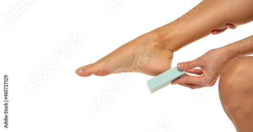 Fotografie Woman scrubing her feet with a pumice stone