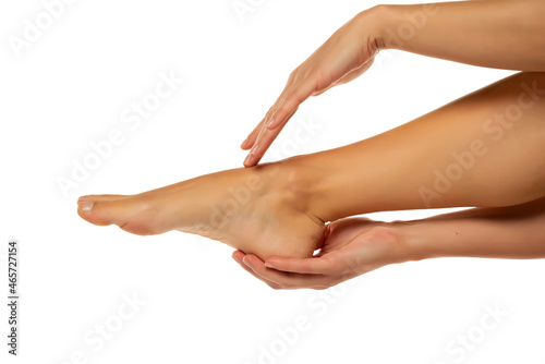 woman's hands holding female feet