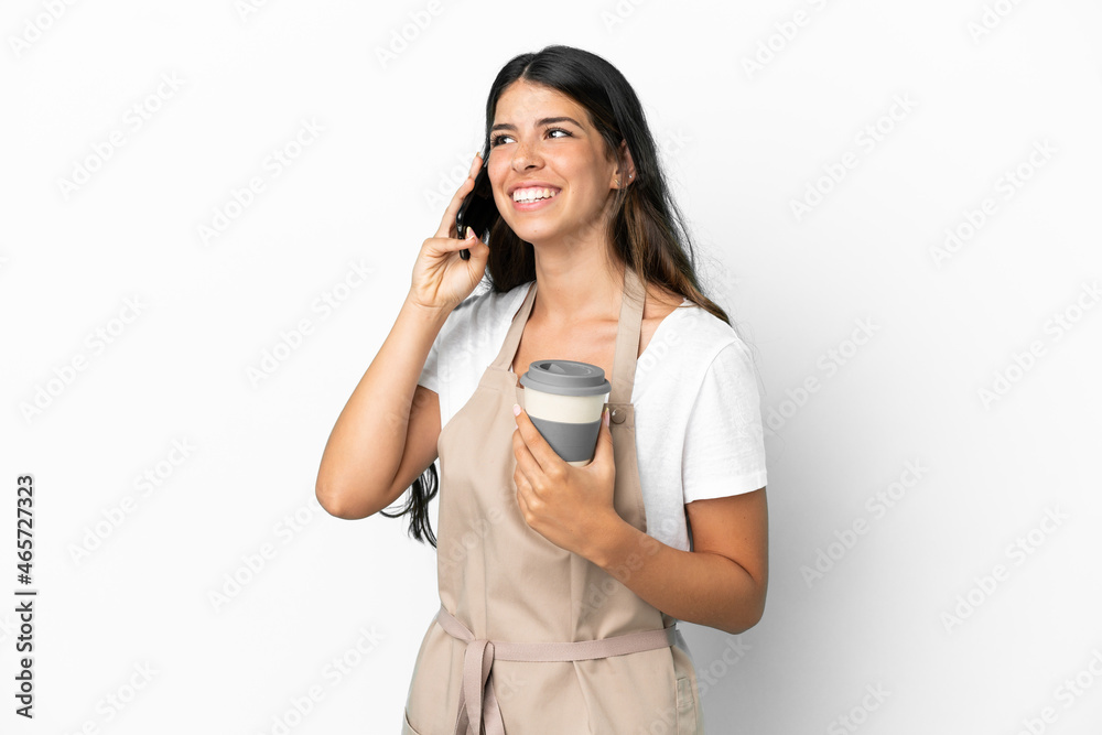 Restaurant waiter over isolated white background holding coffee to take away and a mobile Restaurant waiter over isolated white background holding coffee to take away and a mobile