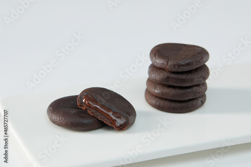 Biscuits filled with chocolate cream. Chocolate cream cookies or Choco fills served with cup of milk photo