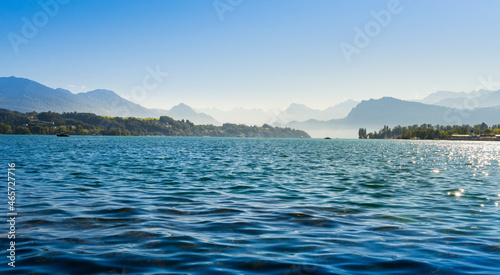 Panoramic view of Lake Lucerne on a clear day and blue sky with the alps in the background.