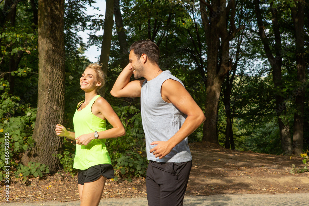 Fototapeta premium Handsome couple jogging together in the nature