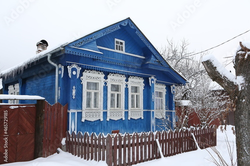 Vintage wooden rural house in Dunilovo village in Ivanovo region, Russia. Building facade; ornamental windows with carved frames. Russian traditional national folk style in architecture. Countryside photo