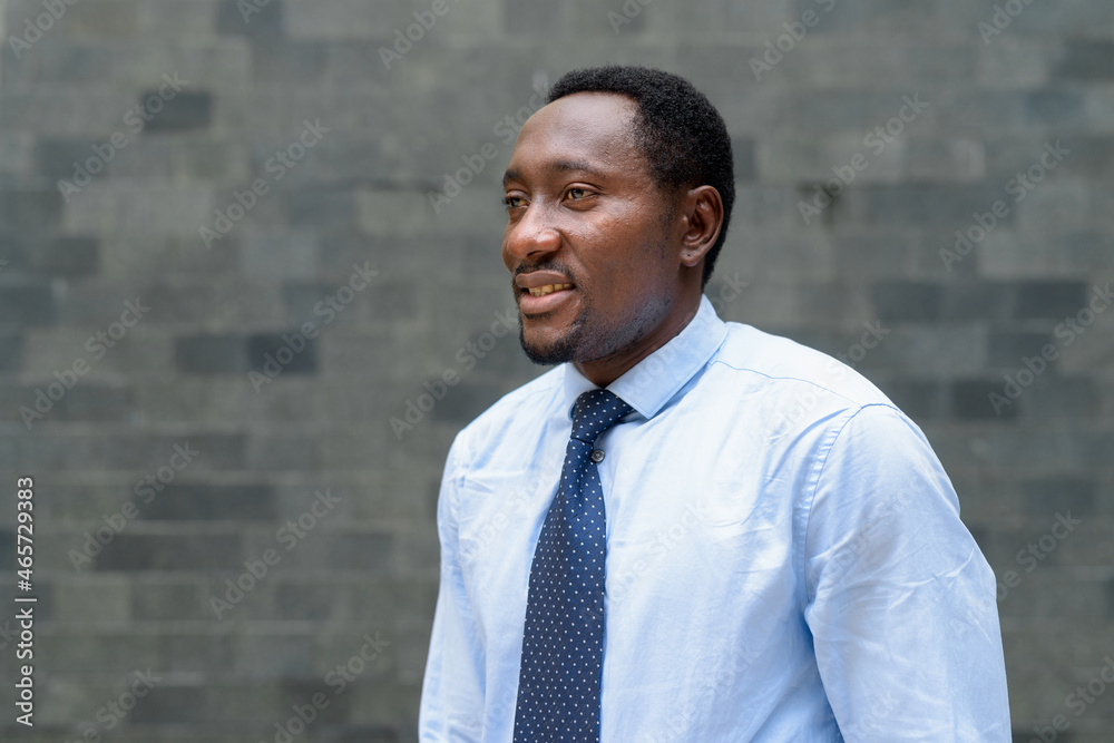 Portrait of handsome African businessman in city thinking Portrait of handsome African businessman in city thinking