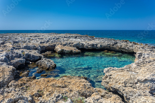 Beautiful view of a beach with rocks in Spiaggia del Frascone ,San isidoro , Italy photo