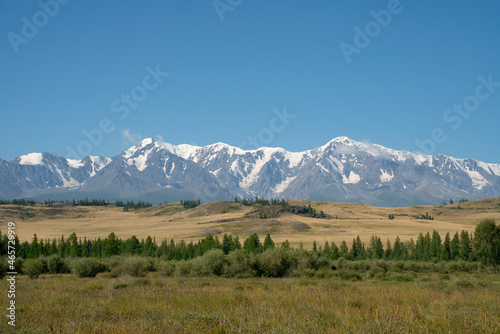 Nice view of snowy mountains and steppe in summer