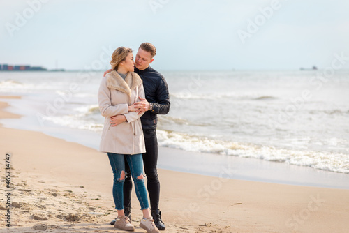 Two Young couple standing enjoying on a coast and enjoying each other.Summer,spring,autumn vacation.