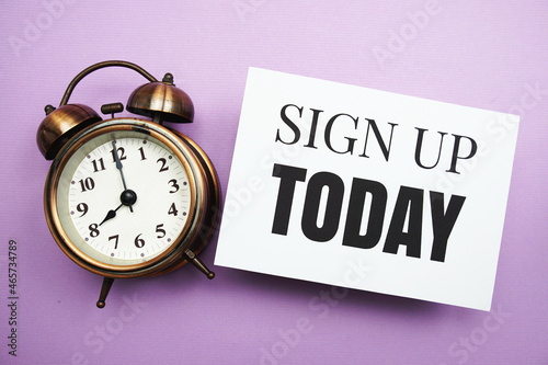 Sign up Today text and alarm clock on purple background
