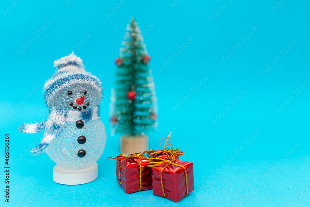 Toy snowman, presents and Christmas tree with copy space.new year celebration.