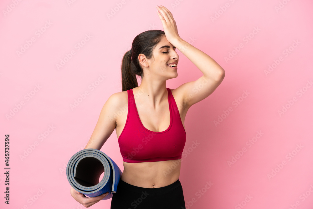 Young sport caucasian woman going to yoga classes while holding a mat has realized something and intending the solution Young sport caucasian woman going to yoga classes while holding a mat has realized something and intending the solution