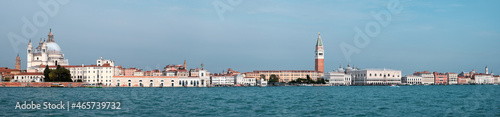 Venice, panoramic image of central Venice from lagoon. City skyline with Punta della Dogana, church Santa Maria della Salute, Doge's palace and St Mark's Campanile tower. Banner composition.