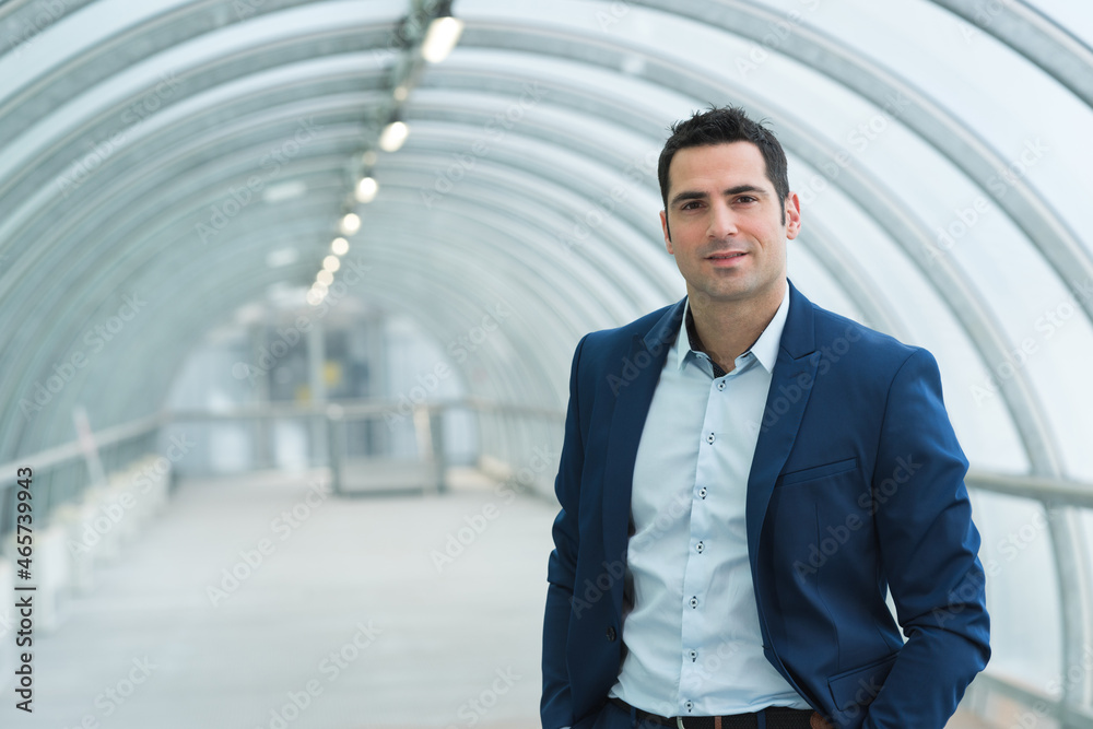 portrait of pleasant businessman is standing in a building portrait of pleasant businessman is standing in a building