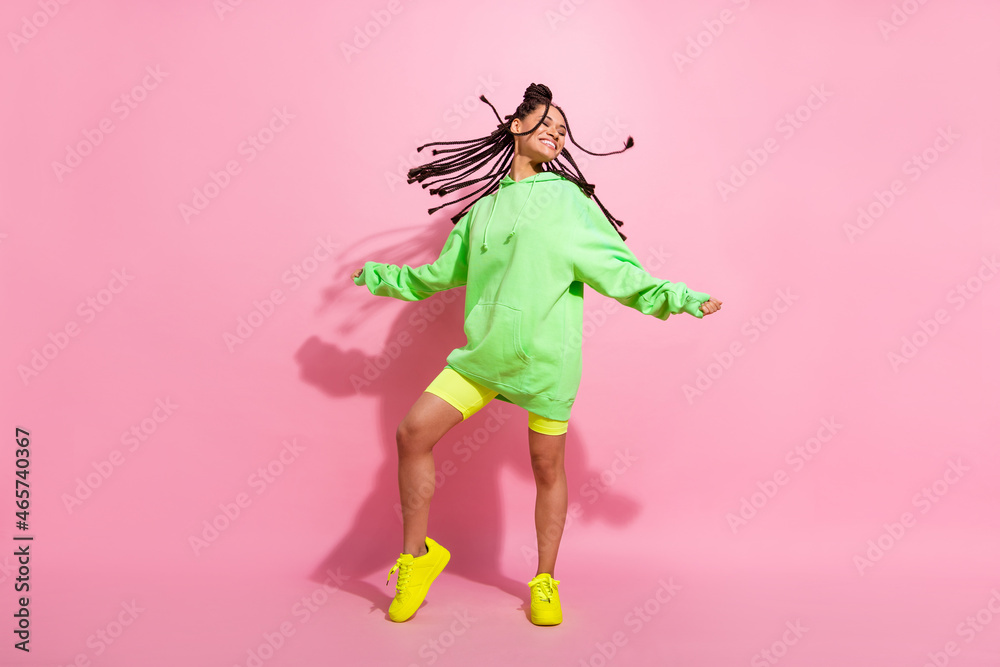 Full body photo of nice dark skin pretty cheerful woman fly hair good mood smile isolated on pink color background Full body photo of nice dark skin pretty cheerful woman fly hair good mood smile isolated on pink color background