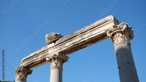Old architectural and pillar at one part of the Library of Celsus, Ephesus, Izmir Turkey. Travel destination of marble arch and sculpture in a classical greek era, Anatolia under a blue sky.