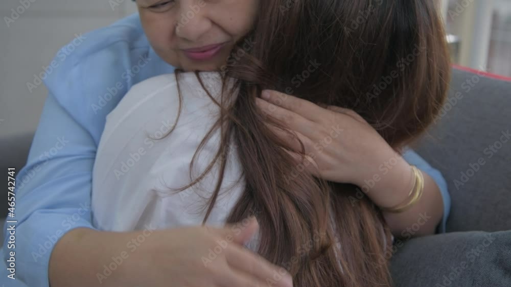 Family concept of 4k Resolution. Mother and daughter hugging in the living room. Family concept of 4k Resolution. Mother and daughter hugging in the living room.