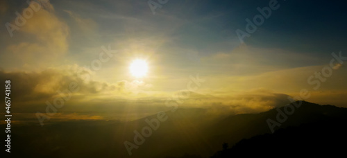 Landscape sunrise over mountains and warm morning sun