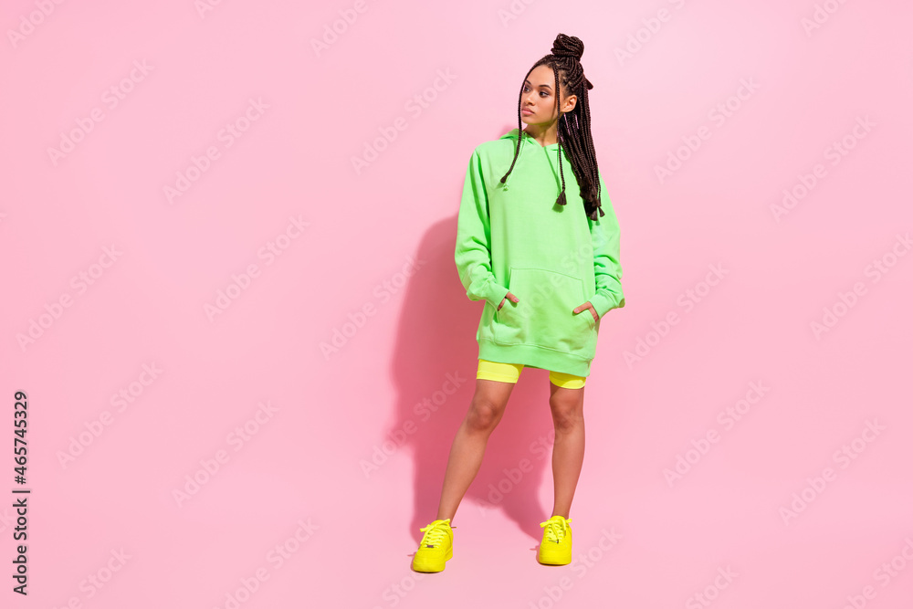 Full size photo of young afro american woman look empty space wear casual outfit isolated on pink color background Full size photo of young afro american woman look empty space wear casual outfit isolated on pink color background