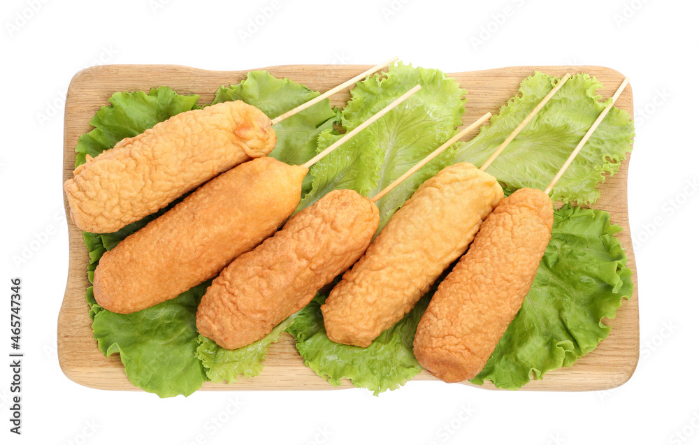 Delicious deep fried corn dogs with lettuce on white background, top view Delicious deep fried corn dogs with lettuce on white background, top view