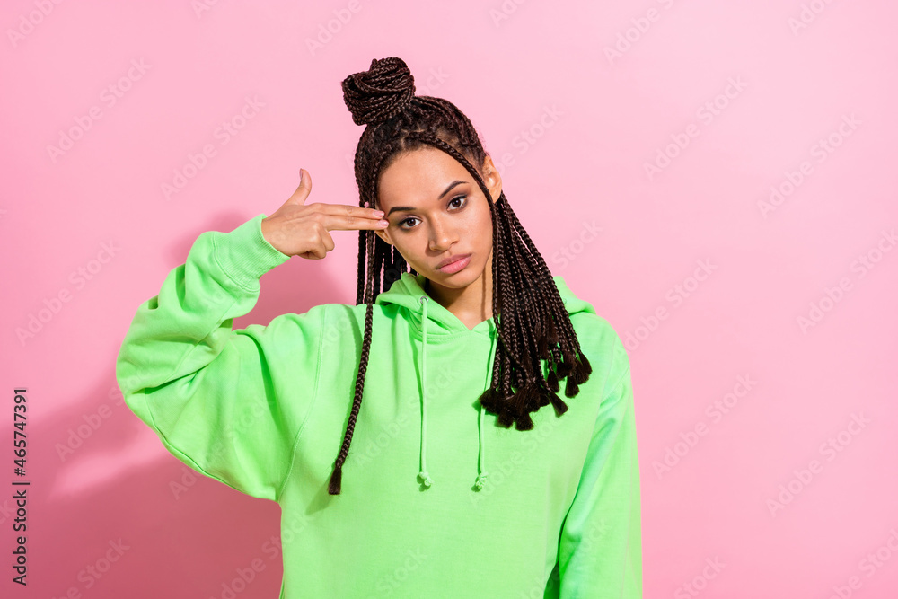 Photo of unhappy upset afro american young woman hold gun fingers head isolated on pink color background Photo of unhappy upset afro american young woman hold gun fingers head isolated on pink color background