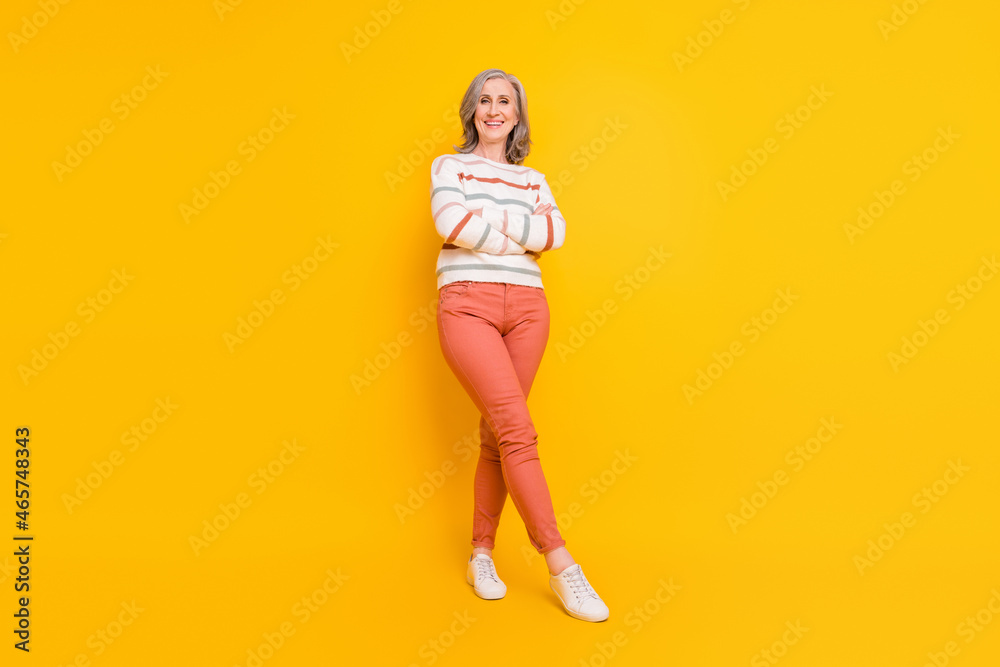 Photo of sweet charming retired woman dressed white sweater smiling hands folded isolated yellow color background Photo of sweet charming retired woman dressed white sweater smiling hands folded isolated yellow color background