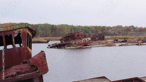 Aerial view of boat, ship and barge graveyard on the Pripyat river abandoned after Chernobyl disaster. Autumn.