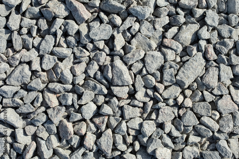 gray stone background. a lot of fine gravel lies on the road gray stone background. a lot of fine gravel lies on the road