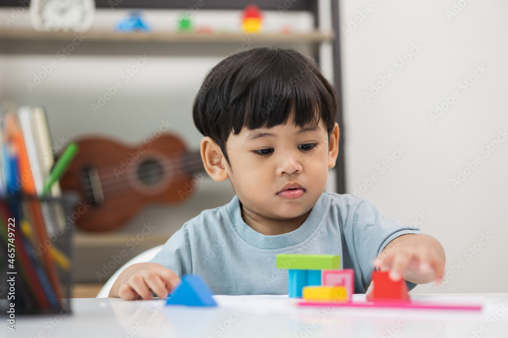 Asian little boy education from home. Developing children's learning before entering kindergarten Practice the skills of playing with wooden toys in living room. Asian little boy education from home. Developing children's learning before entering kindergarten Practice the skills of playing with wooden toys in living room.