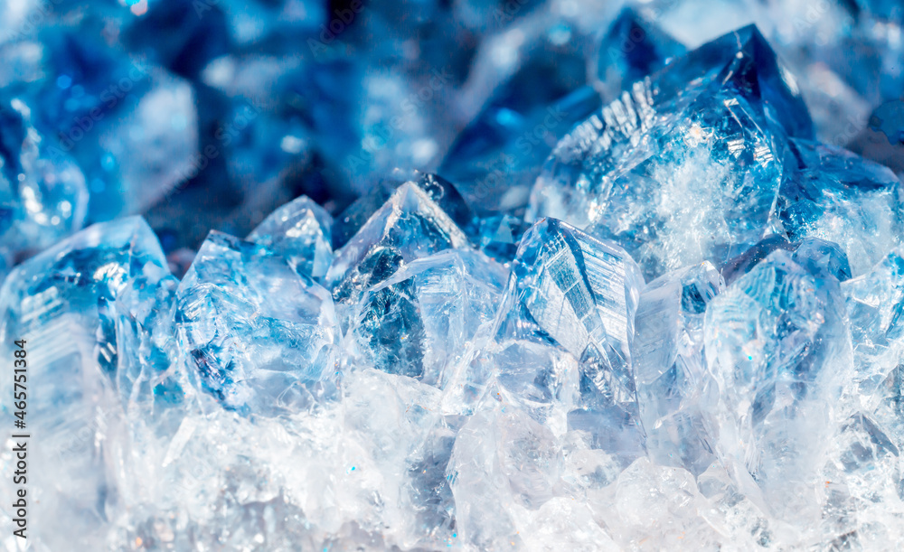Blue Crystal Mineral Stone. Gems. Mineral crystals in the natural environment. Texture of precious and semiprecious stones. Seamless background with copy space colored shiny surface of precious stones