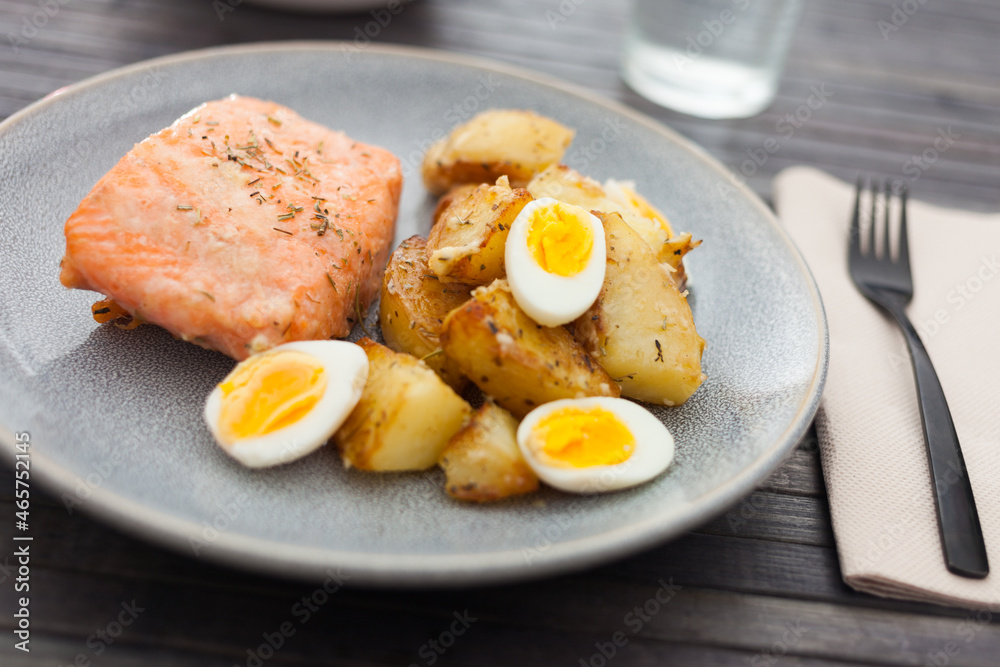 steamed salmon fillet with potato wedges and quail egg