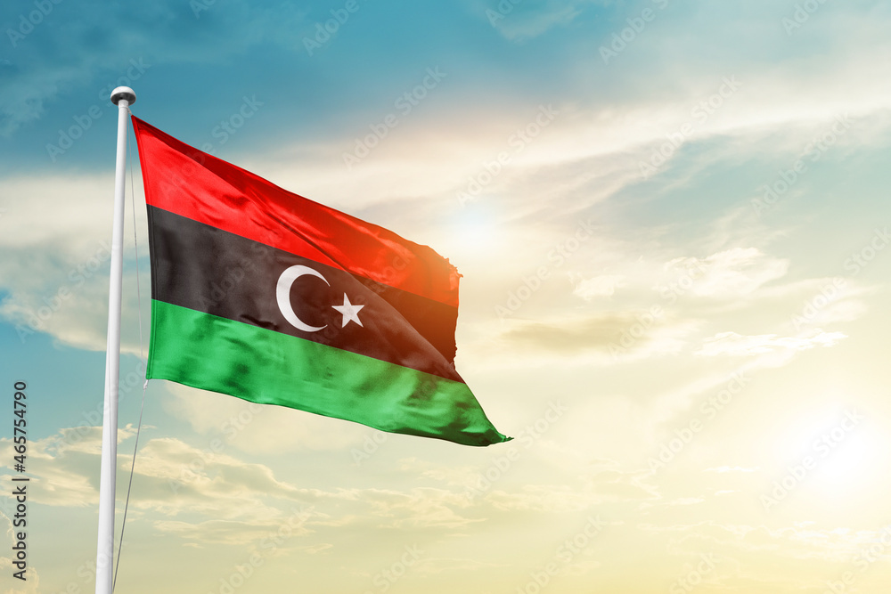 Libya national flag cloth fabric waving on the sky - Image - obrazy, fototapety, plakaty 