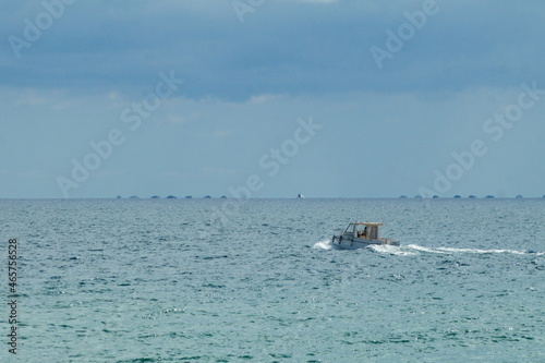 Nice seascape with boats going through the surf in vacation time © JuanPablo
