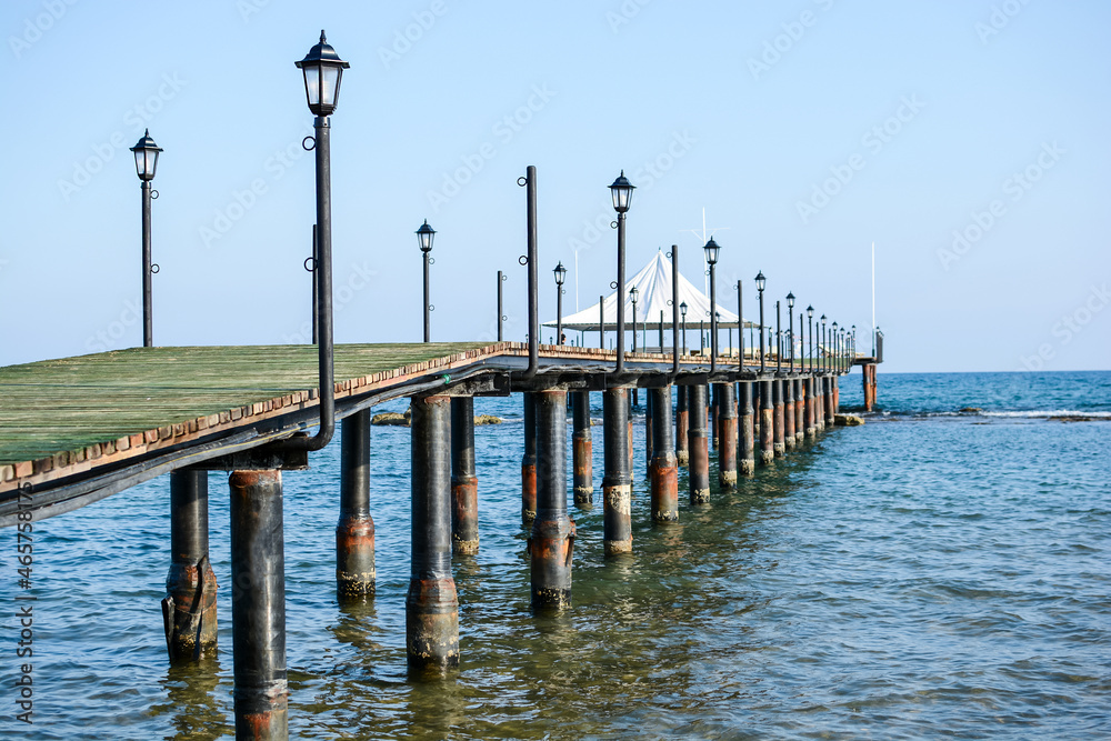 Wooden pier with lanterns. Summer, travel, vacation and vacation at sea.