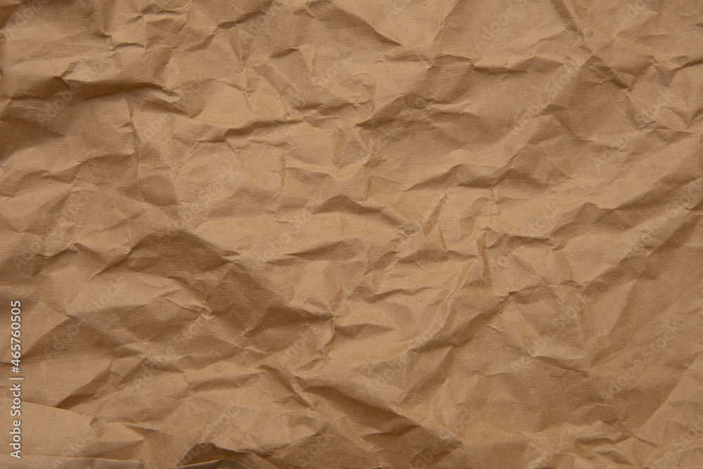 Obraz premium Textured background. Brown rough crumpled kraft paper. Recycled, reuse