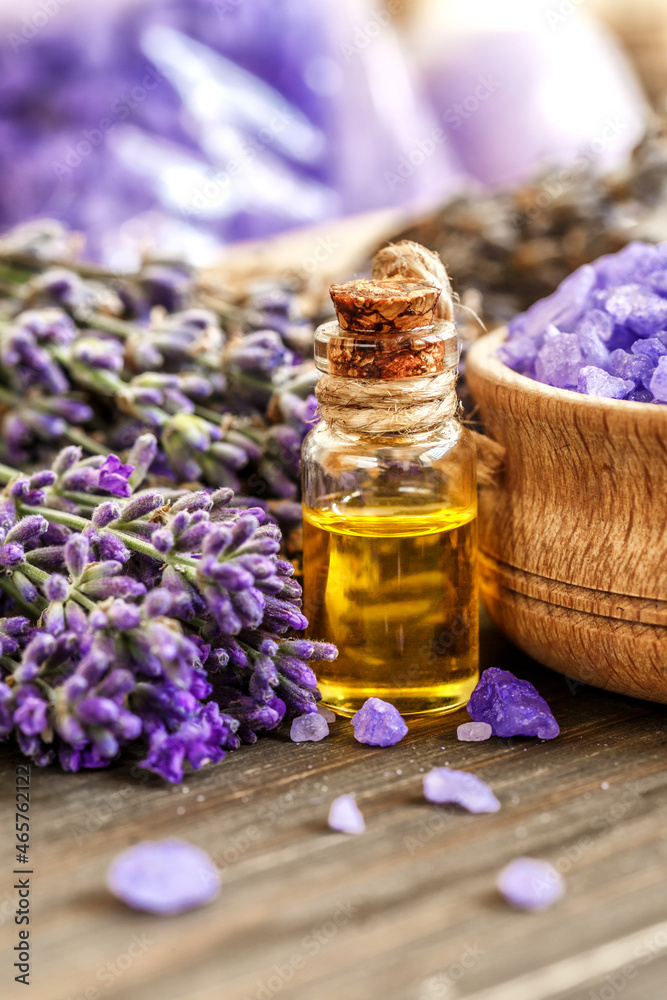 lavender's spa products with dried lavender flowers on a wooden table. Flat lay bath salt and massage oil on wooden background. Skin care, beauty treatment concept. Lavendula oleum lavender's spa products with dried lavender flowers on a wooden table. Flat lay bath salt and massage oil on wooden background. Skin care, beauty treatment concept. Lavendula oleum