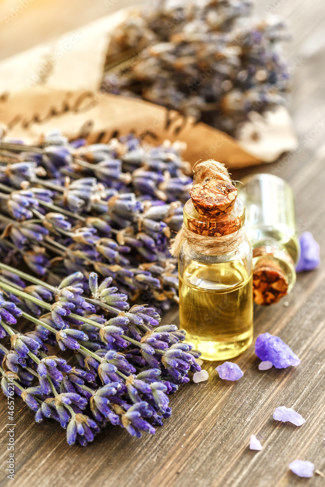 lavender's spa products with dried lavender flowers on a wooden table. Flat lay bath salt and massage oil on wooden background. Skin care, beauty treatment concept. Lavendula oleum lavender's spa products with dried lavender flowers on a wooden table. Flat lay bath salt and massage oil on wooden background. Skin care, beauty treatment concept. Lavendula oleum