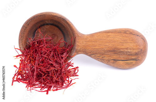 Saffron in wooden spoon, isolated on white background. Natural dry saffron threads, from crocus flowers. Clipping path. photo