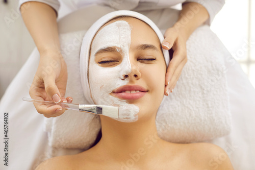 Konstfotografi Happy beautiful young woman or teenage girl with half face covered in calming so