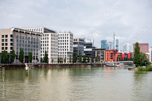 Modern architecture along a river in a city centre on a cloudy day. Frankfurt  Germany.