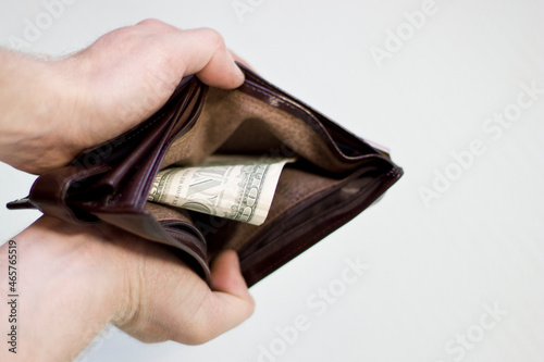 Men's wallet with one bill in hand