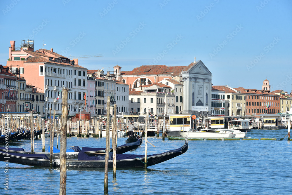 VENICE, AUGUST 24, 2020 - View of Venice landscape with moored gondolas on Grand Canal in the foreground and the St. Mary of the Visitation Church on the background