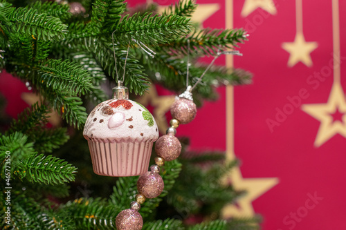 Christmas tree branch with christmas tree toy cake muffin cupcake and garland, christmas background for card and invitation