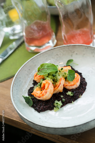 Black risotto with roasted shrimps