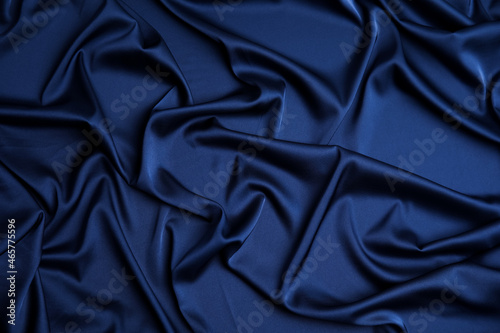 Canvas Crumpled dark blue silk fabric as background, top view